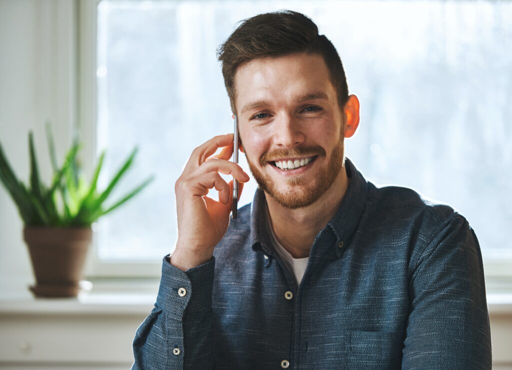 Smiling man talking on phone